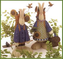 ww7403 Two rabbits, one in a smock, one in pants, with garden tools, flowers, carrots and bees