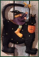 WW6024 A witch with moon and star riding a black cat
